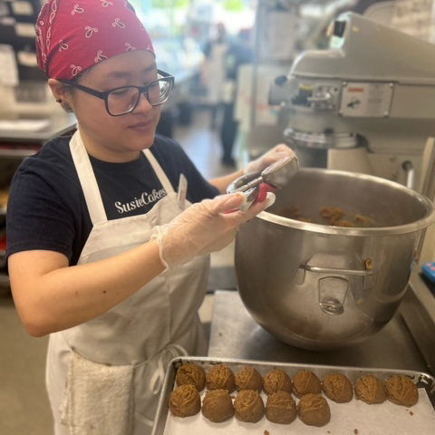 Employee Sugaring a Cake