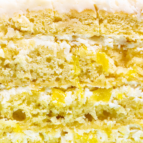 Tropical Coconut Cake on Cake Stand - SusieCakes  - Side Cut view 3