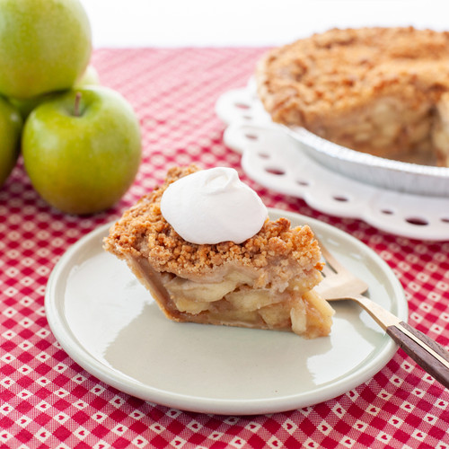 slice of SusieCakes Apple Crumble Pie showing Granny Smith apple filling and flaky crust is the perfect dessert to bring for Thanksgiving view 3