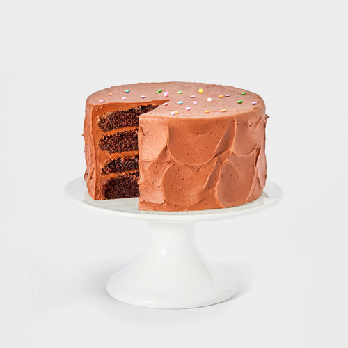 Image 1: Chocolate cake shown on a white background with a slice cut out so you can visually see the 4 layers of moist chocolate cake with the chocolate buttercream.